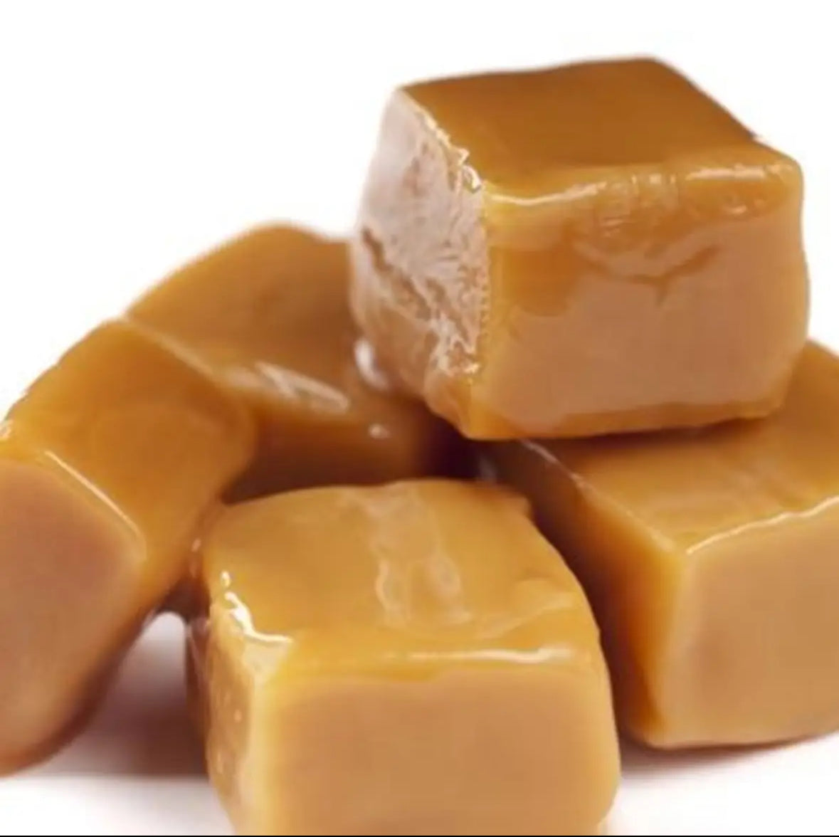 A close-up pile of glossy caramel candies on a white background.