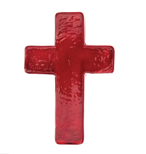 A glossy, textured red cross-shaped glass vessel or candle holder, isolated on a solid white background.