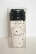 Packaged set of to-go cups with black lids and heart patterns on white background