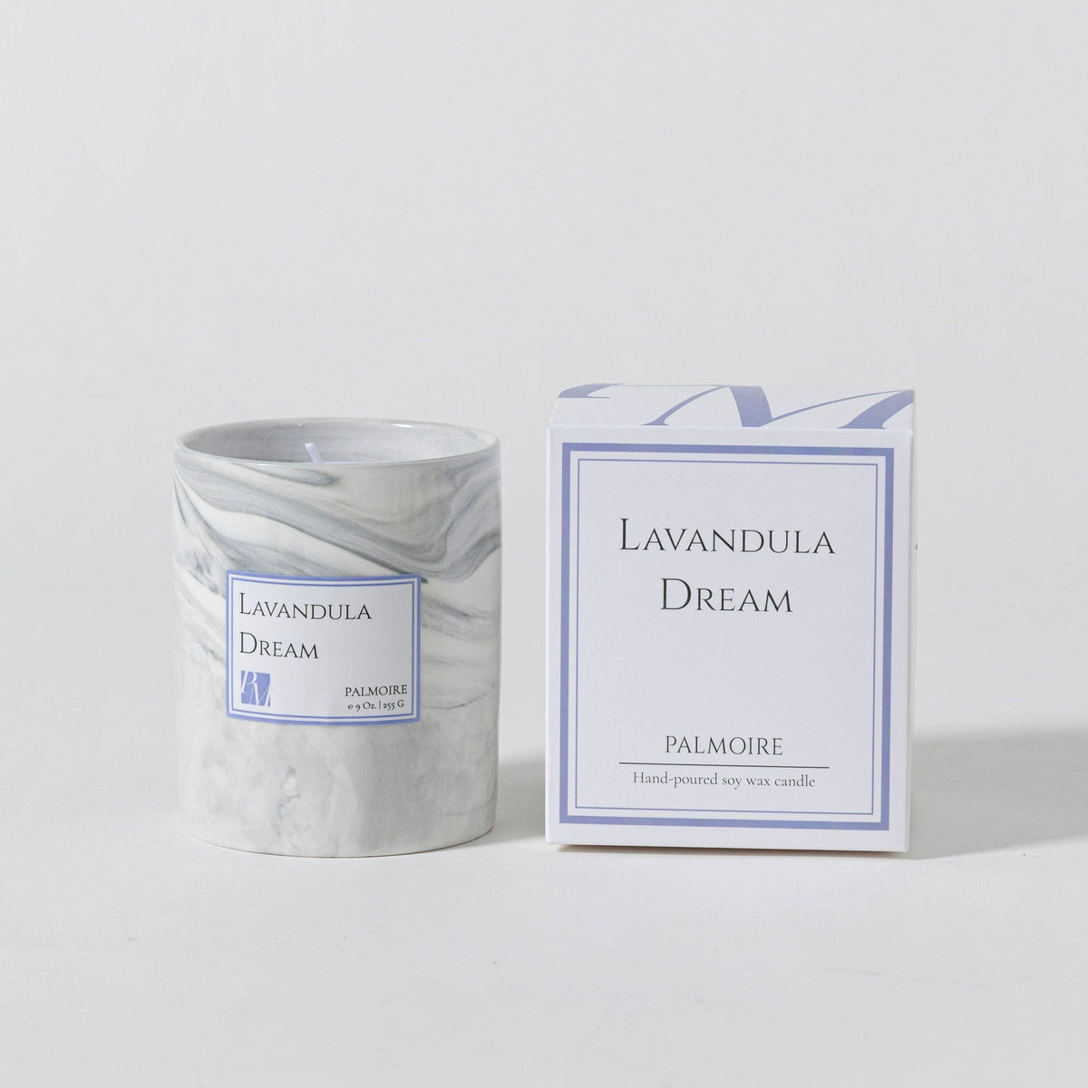 Marble-patterned candle and its packaging labeled 'Lavandula Dream' on a light gray background