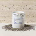 Candle labeled 'Lavandula Dream' with lavender and rosemary on a light background