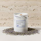 Candle labeled 'Lavandula Dream' with lavender and rosemary on a light background