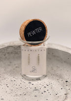 Pewter jewelry on a Chemistry display with cork lid