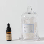 Product packaging with a bottle, jar, and box on a white background. Quartz gemstone cloche diffuser