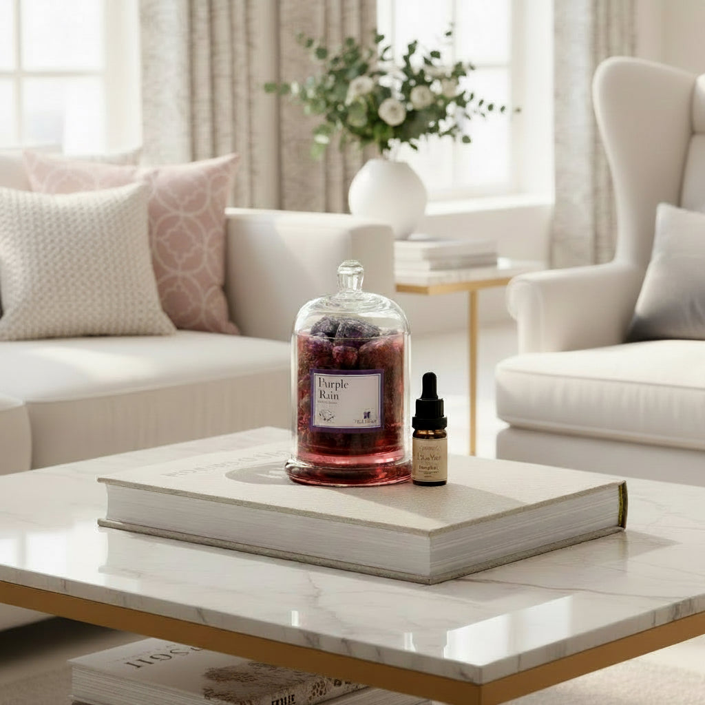 FULL MOOD Purple Rain amethyst gemstone diffuser in a glass cloche with fragrance oil on a marble coffee table