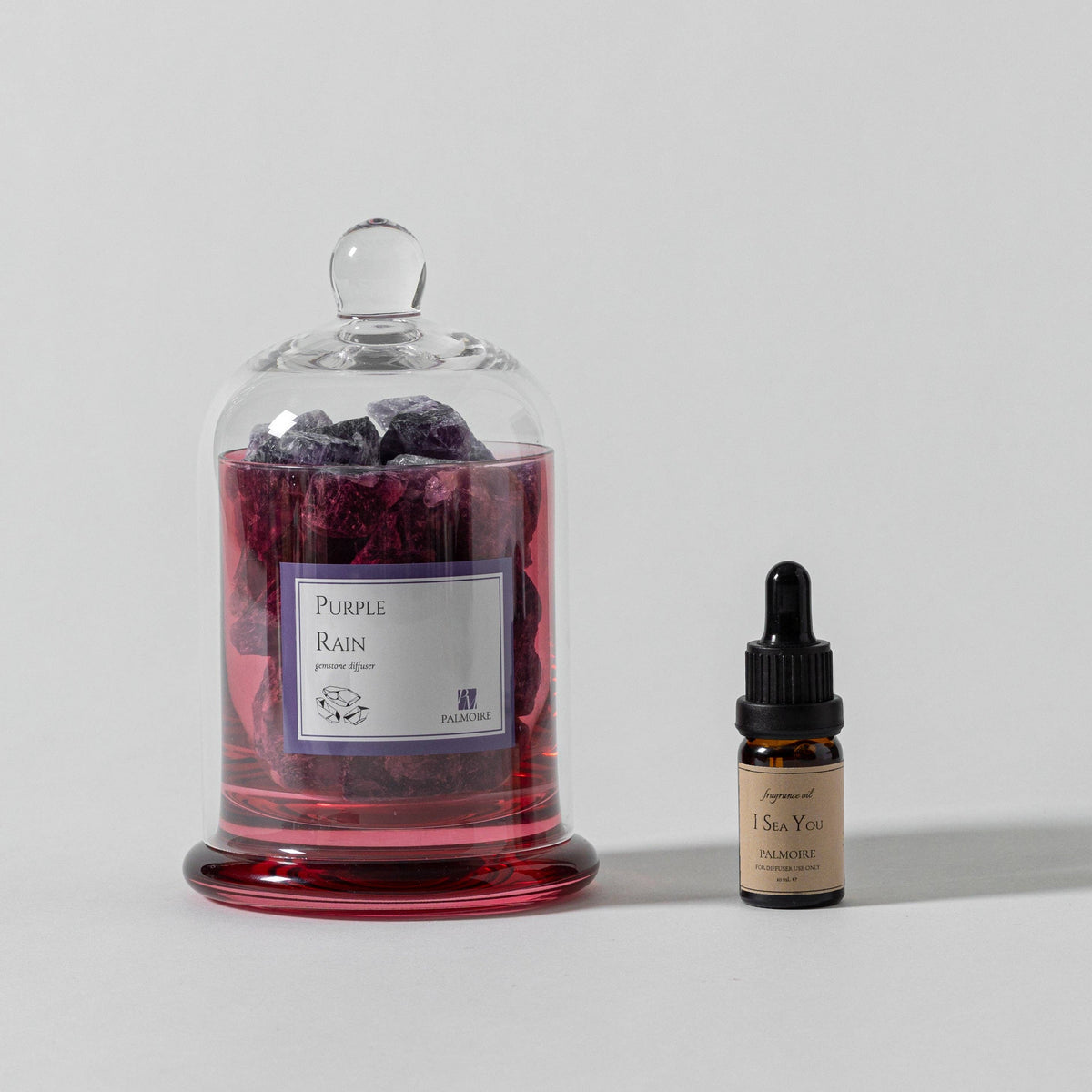 FULL MOOD Purple Rain amethyst gemstone diffuser in a glass cloche with a small bottle of fragrance oil
