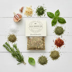 FULL MOOD Benamati Bread Oil gourmet seasoning mix surrounded by fresh garlic, rosemary, basil, and dried spices.