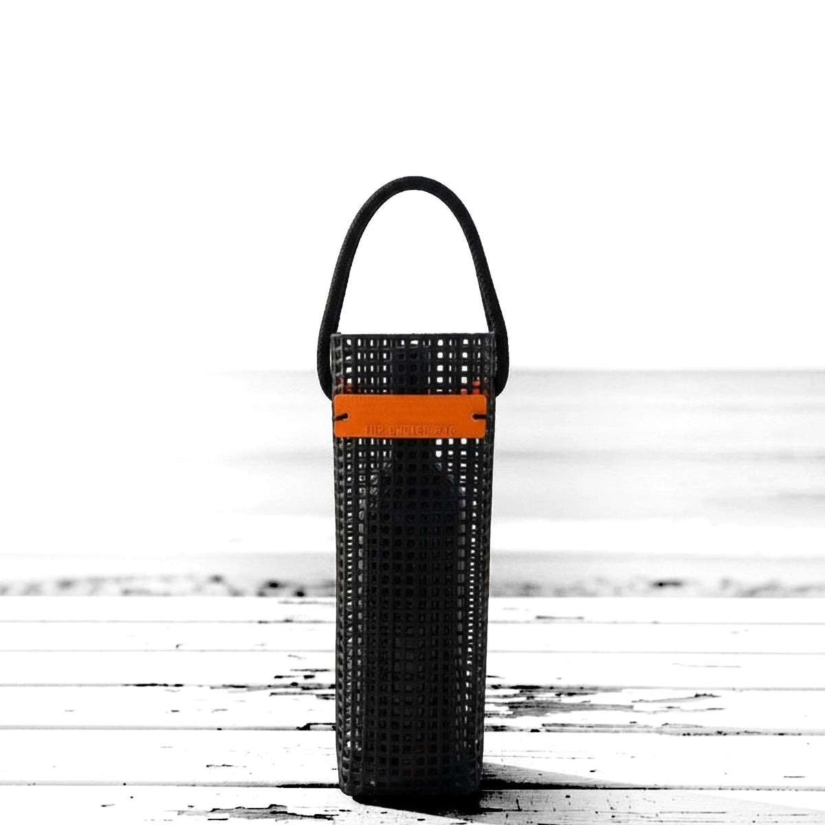 FULL MOOD black oyster wine caddy made from durable aquaculture material with an orange accent strap