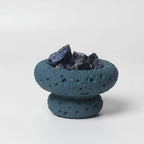 FULL MOOD Caribbean aromatherapy diffuser with blue sodalite gemstones in a textured blue moon-shaped stone vessel.