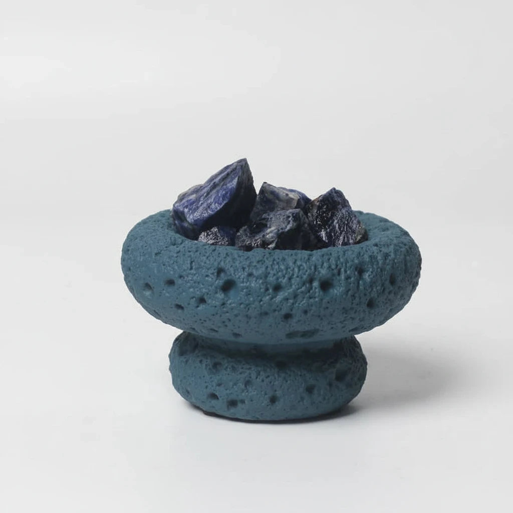 FULL MOOD Caribbean aromatherapy diffuser with blue sodalite gemstones in a textured blue moon-shaped stone vessel.