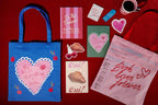 FULL MOOD canvas tote bags featuring library card and heart designs, displayed with stationery on a red background.