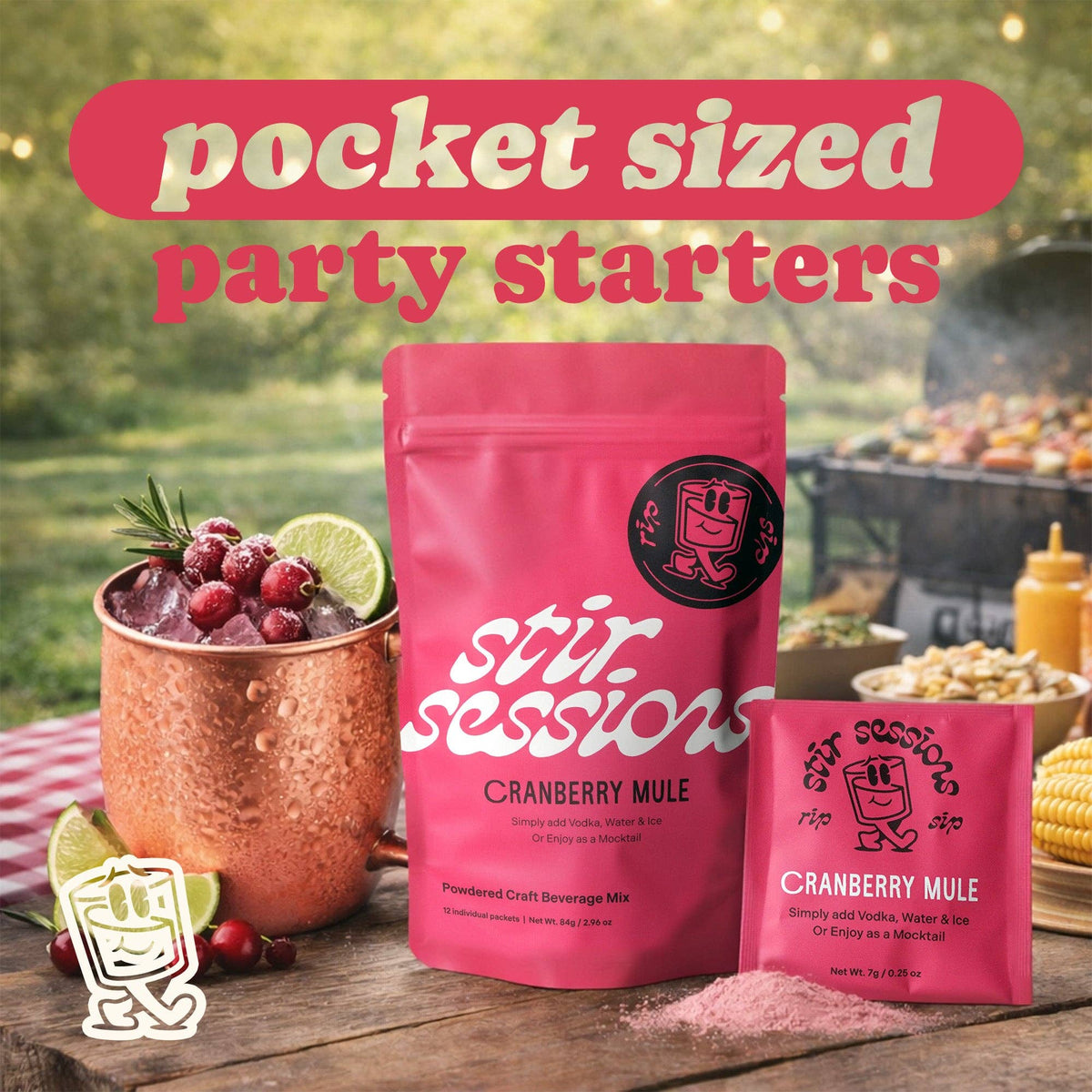 FULL MOOD Stir Sessions Cranberry Mule cocktail mix packets with a prepared drink in a copper mug on a picnic table.