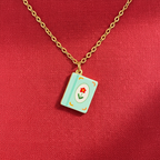 FULL MOOD 18K gold-plated stainless steel necklace featuring a light blue enamel book pendant with a red flower.