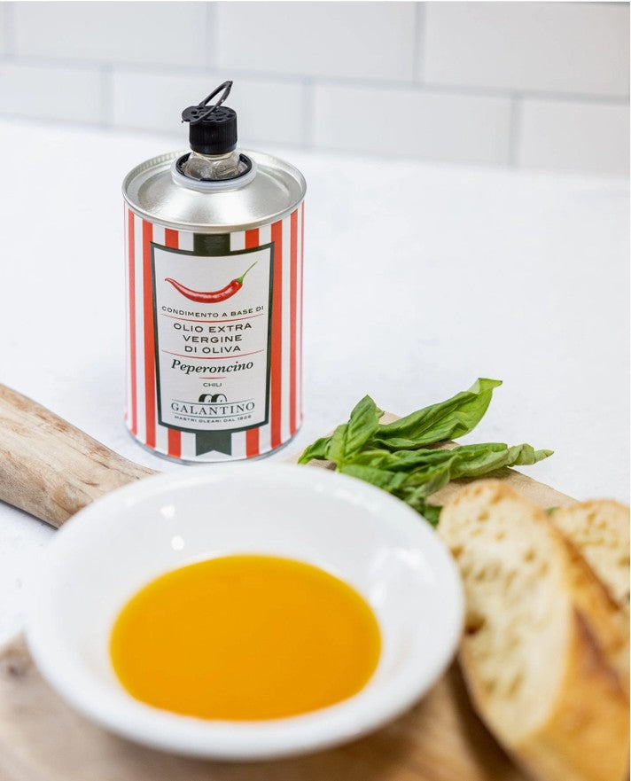 FULL MOOD Frantoio Galantino spicy chili extra virgin olive oil in a decorative striped tin with bread and basil