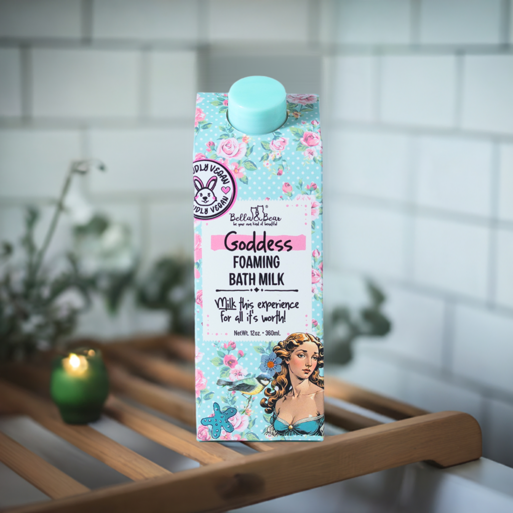 FULL MOOD Goddess Foaming Bath Milk in floral packaging with a tropical design, sitting on a wooden bath tray.