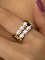 FULL MOOD 18K gold plated stainless steel ring featuring two rows of freshwater pearls and beaded edges on a finger.