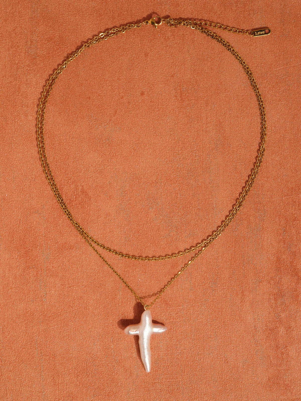FULL MOOD 18K gold plated double-layered chain necklace featuring a freshwater pearl cross pendant on orange background