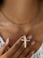 FULL MOOD 18K gold double-layered chain necklace featuring a lustrous freshwater pearl cross pendant on a model.
