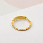 FULL MOOD curved shell ring in 18K gold plated stainless steel with a high polish finish on a white surface.