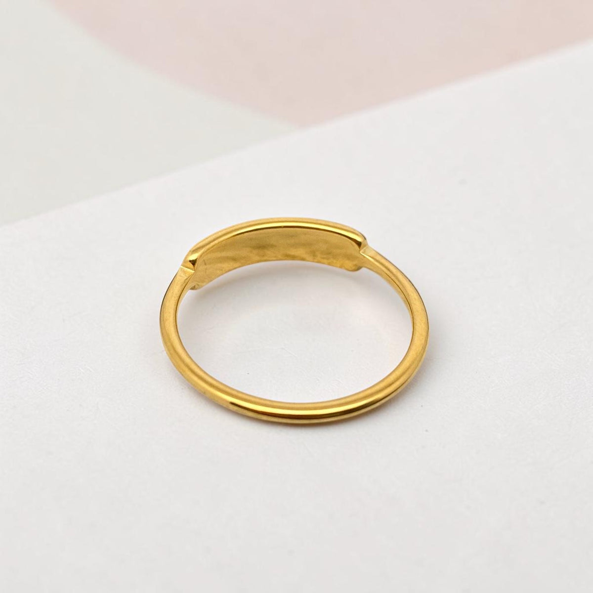 FULL MOOD curved shell ring in 18K gold plated stainless steel with a high polish finish on a white surface.