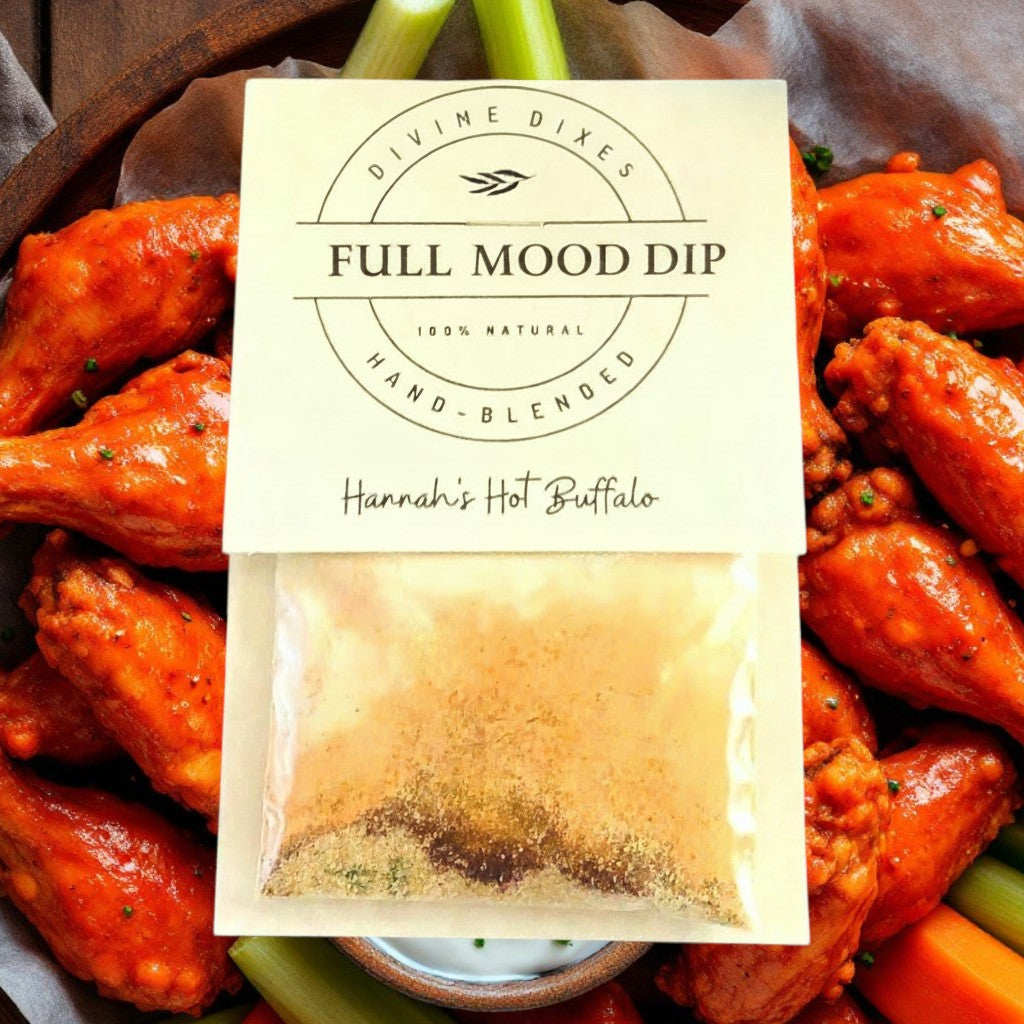 FULL MOOD Hannah's Hot Buffalo seasoning dip mix packet resting on a wooden platter of spicy buffalo chicken wings.