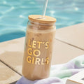FULL MOOD 16oz glass cold brew tumbler with bamboo lid, glass straw, and Let's Go Girls gold text by a pool.