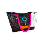 FULL MOOD Mini Market tote bag in black open-grid plastic with bright pink rope handles on an orange crate at beach