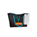 FULL MOOD Mini Market tote bag in black open-grid plastic with blue rope handles, set on an orange crate at the beach.
