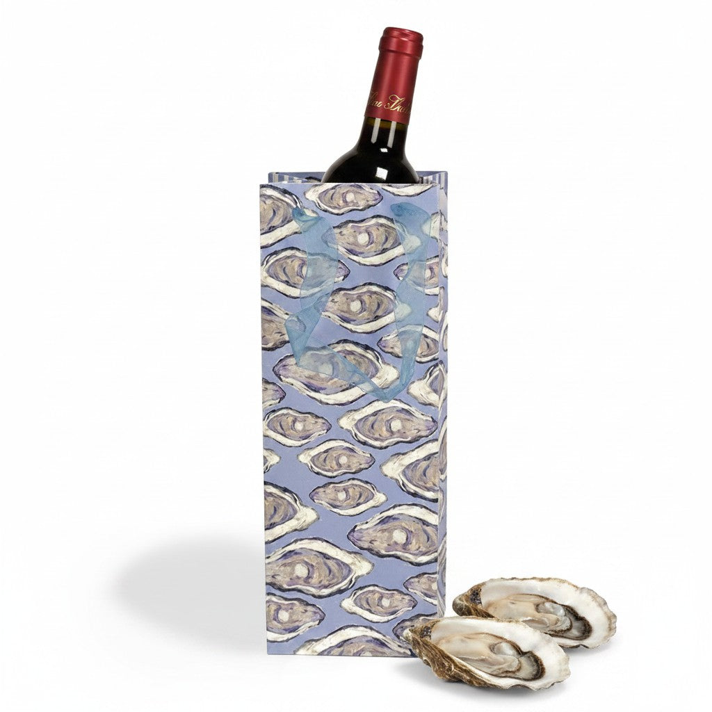 FULL MOOD blue paper wine gift bag featuring an oyster shell pattern with ribbon handles and a bottle inside