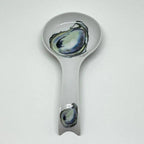 FULL MOOD porcelain oyster spoon rest with a white finish and blue and green oyster shell illustrations.
