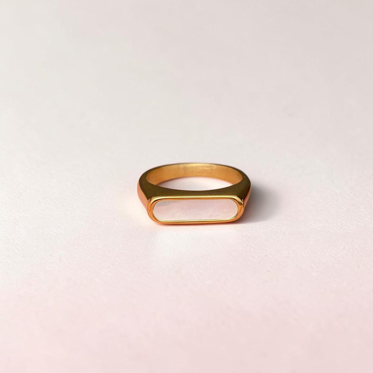 FULL MOOD shell inlaid rings in gold and silver plated stainless steel with a high polish finish on a finger