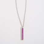 FULL MOOD silver vertical bar pendant necklace with purple enamel inlay and the word Queen engraved on a chain.
