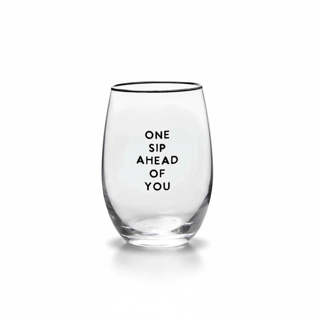 FULL MOOD stemless wine glass featuring the black text One Sip Ahead of You on clear glass against a white background