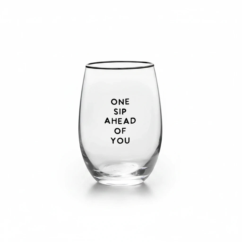 FULL MOOD stemless wine glass featuring the black text One Sip Ahead of You on clear glass against a white background