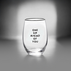 FULL MOOD stemless wine glass featuring the black text One Sip Ahead of You on clear glass