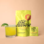 FULL MOOD Stir Sessions Classic Paloma cocktail mix pouch and packet with a prepared margarita on a beige background
