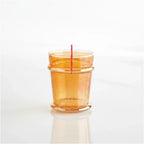 FULL MOOD tangerine luster glass with an iridescent finish and unique rim detail on a white reflective surface.