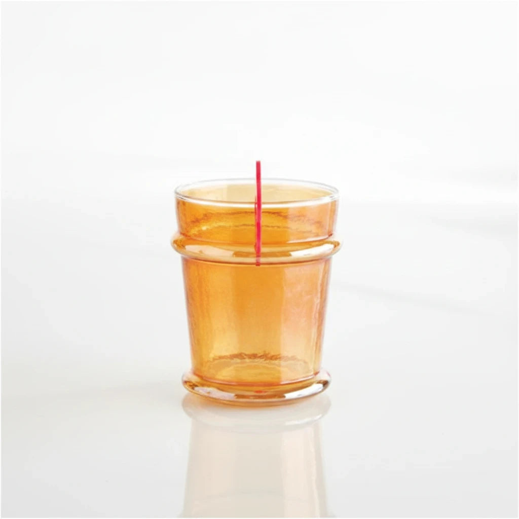 FULL MOOD tangerine luster glass with an iridescent finish and unique rim detail on a white reflective surface.
