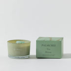 FULL MOOD Tea House soy wax candle in a green glass jar with genuine gemstones next to its matching green box.
