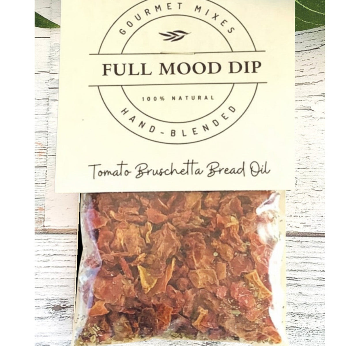 FULL MOOD Tomato Bruschetta seasoning dip mix in a clear pouch with a cream label on a rustic wooden surface.