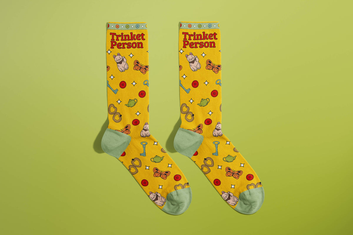 FULL MOOD yellow crew socks featuring a Trinket Person print with tiny ceramic frogs, buttons, and butterflies.