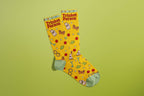 FULL MOOD yellow crew socks featuring a Trinket Person print with tiny ceramic frogs, buttons, and keys on green background