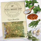FULL MOOD Tuscan Seasoning Dip Mix packet with fresh parsley, thyme, sage, garlic, and red pepper flakes on marble