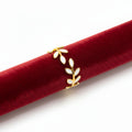 FULL MOOD adjustable ring featuring white enamel foliage leaves on 18K gold-plated stainless steel on a red velvet roll