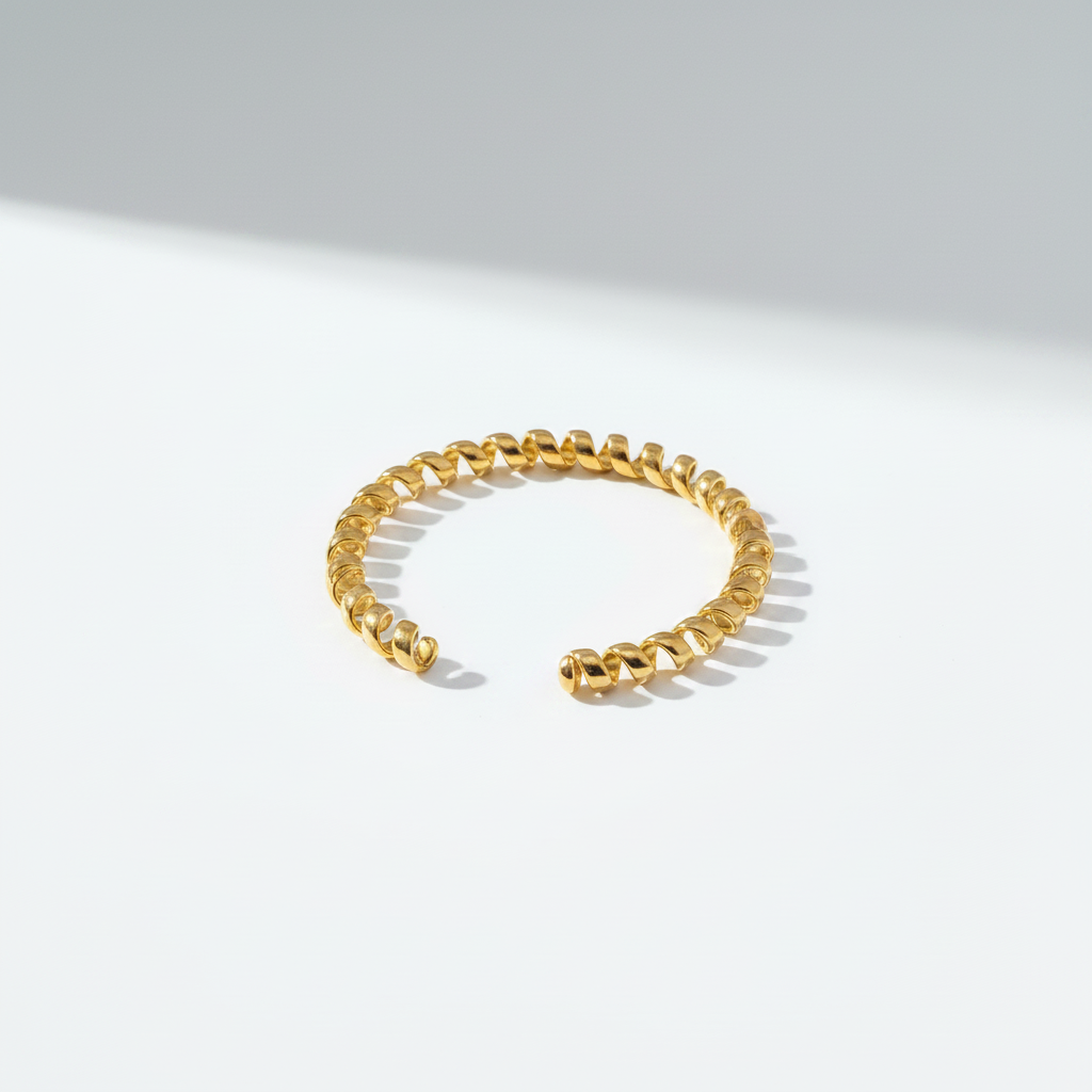 18K gold plated telephone line spiral cuff bracelet on cool white background