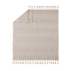 Beige patterned rug with tassels on a white background